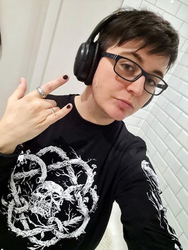 headshot of Ren Erickson, a masc presenting person with dark short hair and glasses